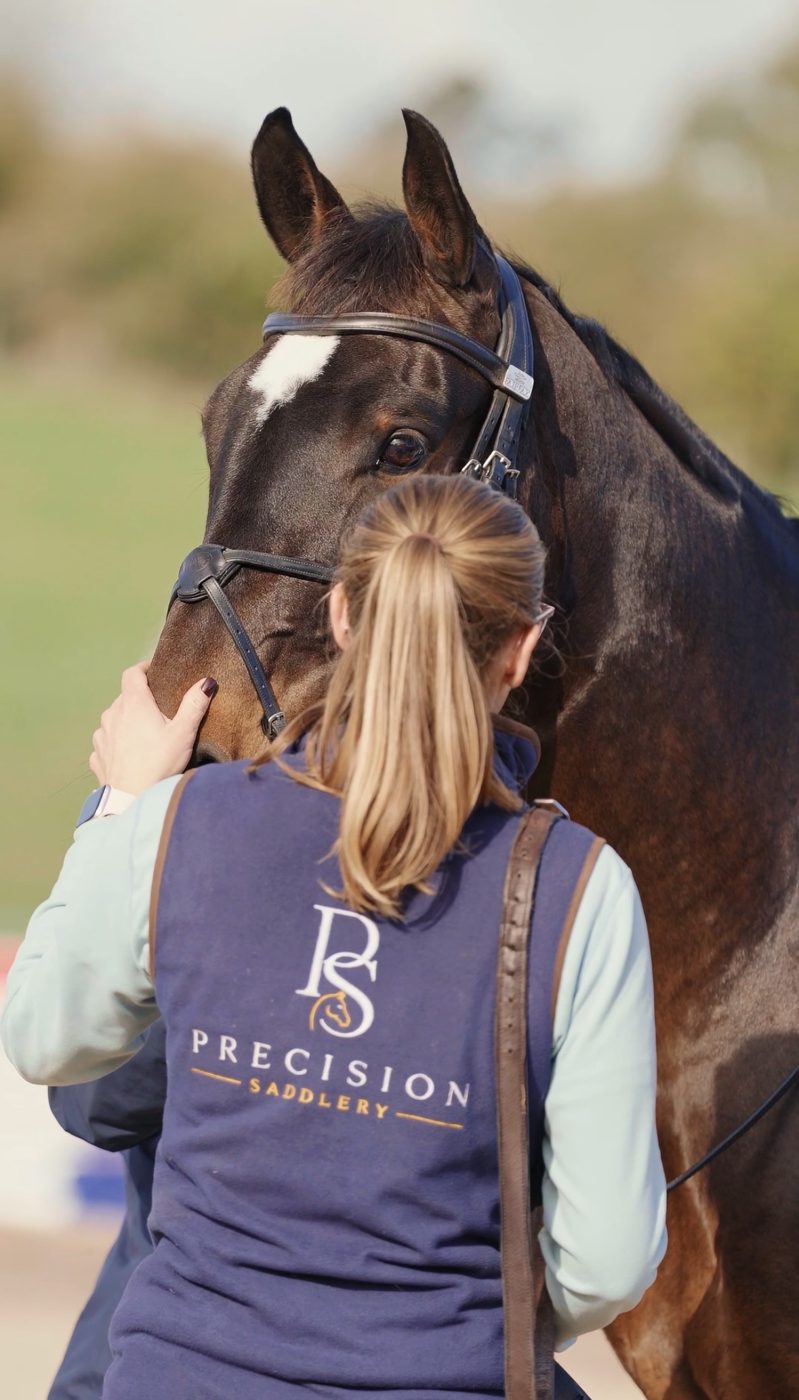 Rhi in her Precision Saddlery gilet with a bay horse